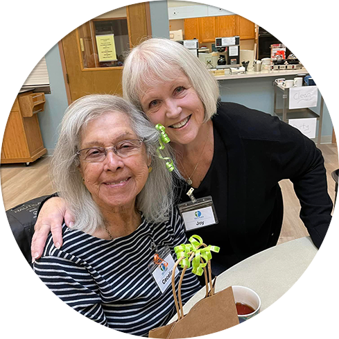 two smiling ladies hugging